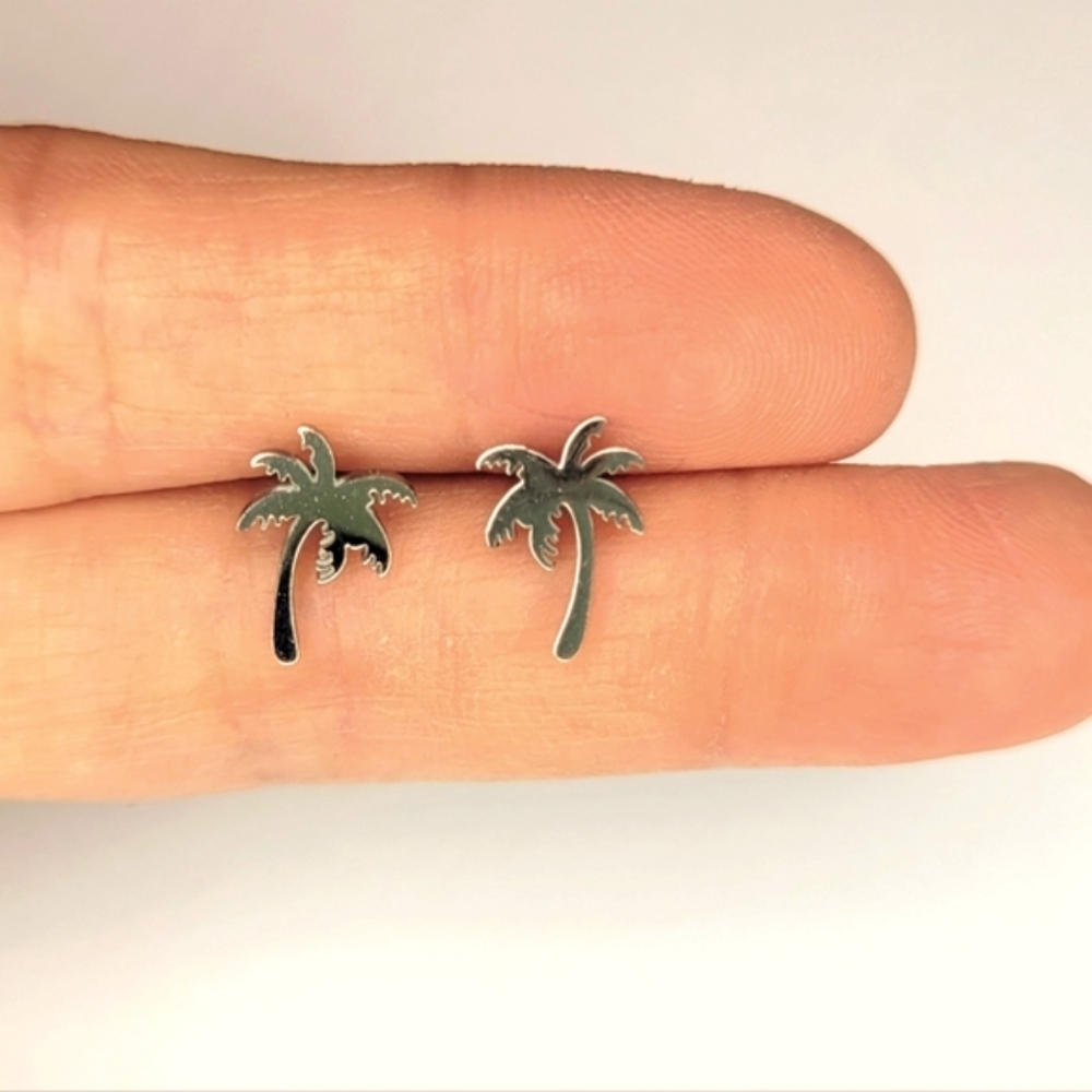 Set of palm tree shaped silver color stainless steel stud earrings. Brand new.